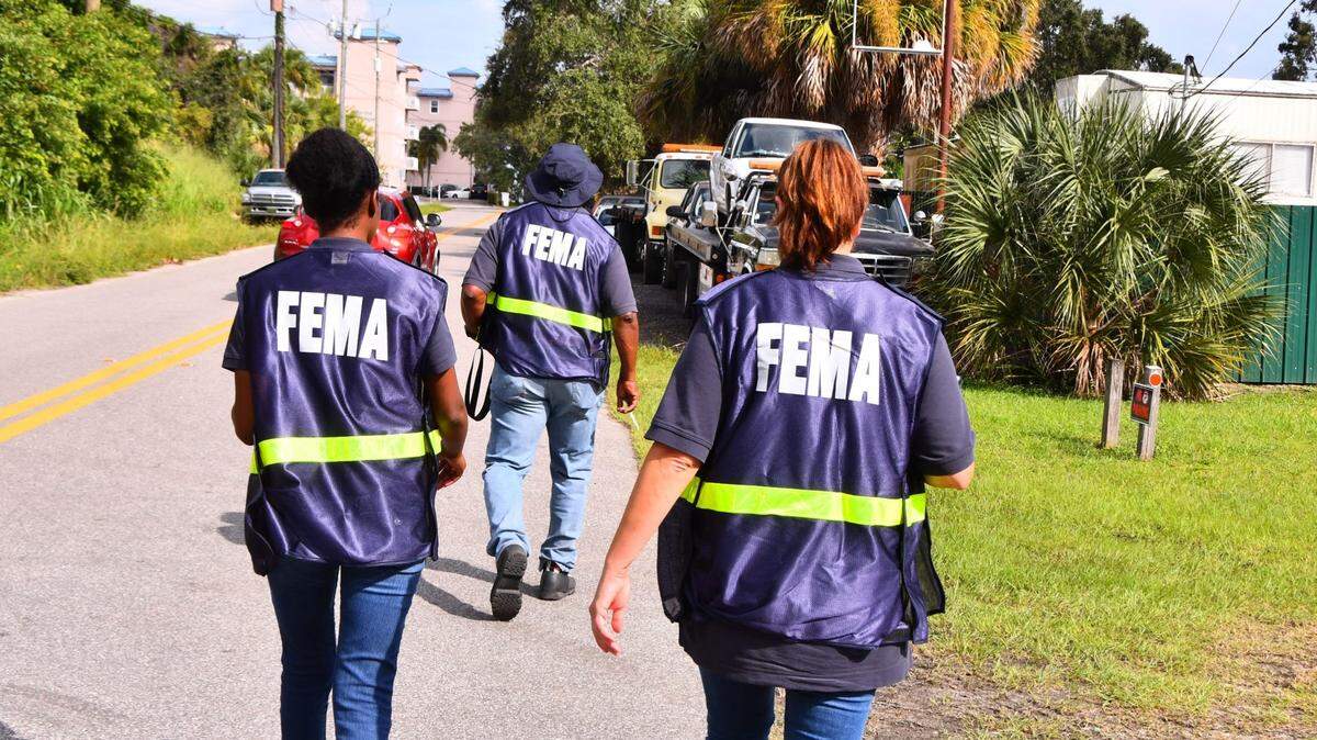 In October 2022, after Hurricane Ian struck, FEMA workers canvass neighborhoods on Florida's Merritt Island, talking to residents in flooded areas.
