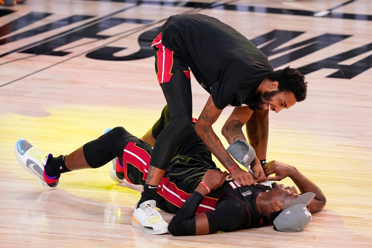 Miami Heat’s Bam Adebayo, on the court, celebrates with a teammate after their win over the Boston Celtics in a NBA conference final playoff basketball game Sunday, Sept. 27, 2020, in Lake Buena Vista, Fla. (AP Photo/Mark J. Terrill)