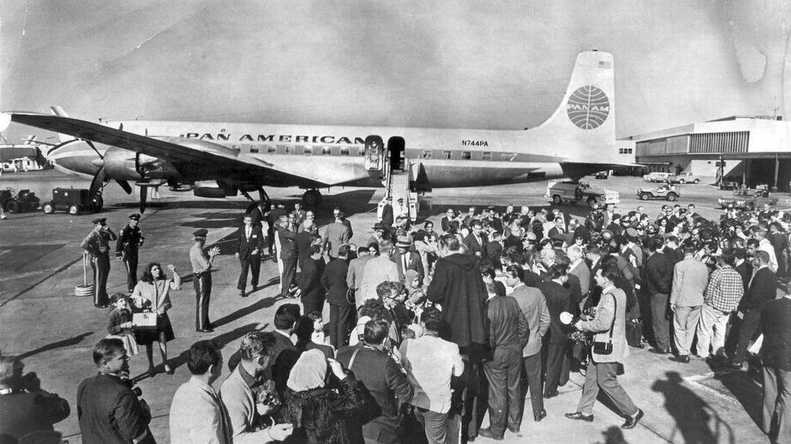 Cuban refugees aboard the historic first Freedom Flight arrive at Miami International Airport on Dec. 1, 1965 to a sea of relatives and reporters.