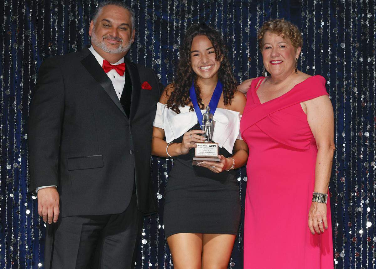 Silver Knight winner Gabriela Gonzalez-Orbegoso, from Schools for Advanced Studies West Campus, celebrates after winning in the Athletics category as she stands with Alex Mena, Executive Editor of the Miami Herald & el Nuevo Herald and Dana Banker, Managing Editor at the Miami Herald. 