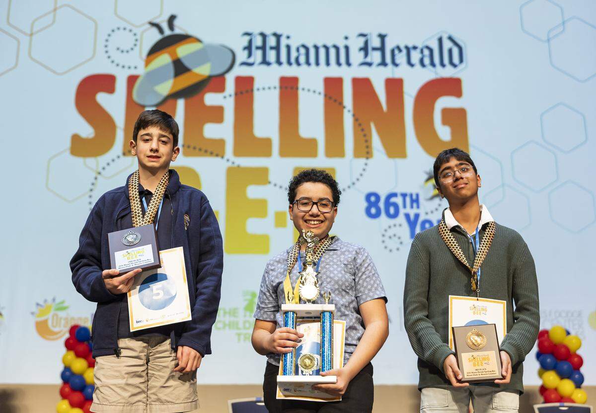 From left to right: David Furman, Logan Cox, and Nikhil Sha gather for a group photo after participating in the 86th Miami Herald Spelling Bee for Miami-Dade and Monroe County at the Charles F. Dodge City Center on Wednesday, Feb. 25, 2026, in Pembroke Pines, Fla. Cox came in first place during the competition.