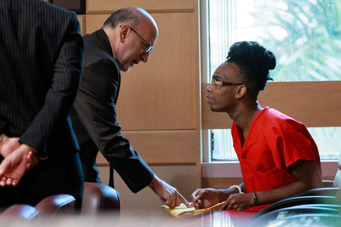 Jamell Demons, better known as rapper YNW Melly speaks with his attorney Stuart Adelstein during a bond hearing before Broward Circuit Judge John Murphy on Friday, September 15, 2023. His previous trial ended in a mistrial after the jury was deadlocked and unable to reach a verdict in July 2023. Demons, 24, is accused of killing two fellow rappers and conspiring to make it look like a drive-by shooting in October 2018. (Mike Stocker/South Florida Sun Sentinel)