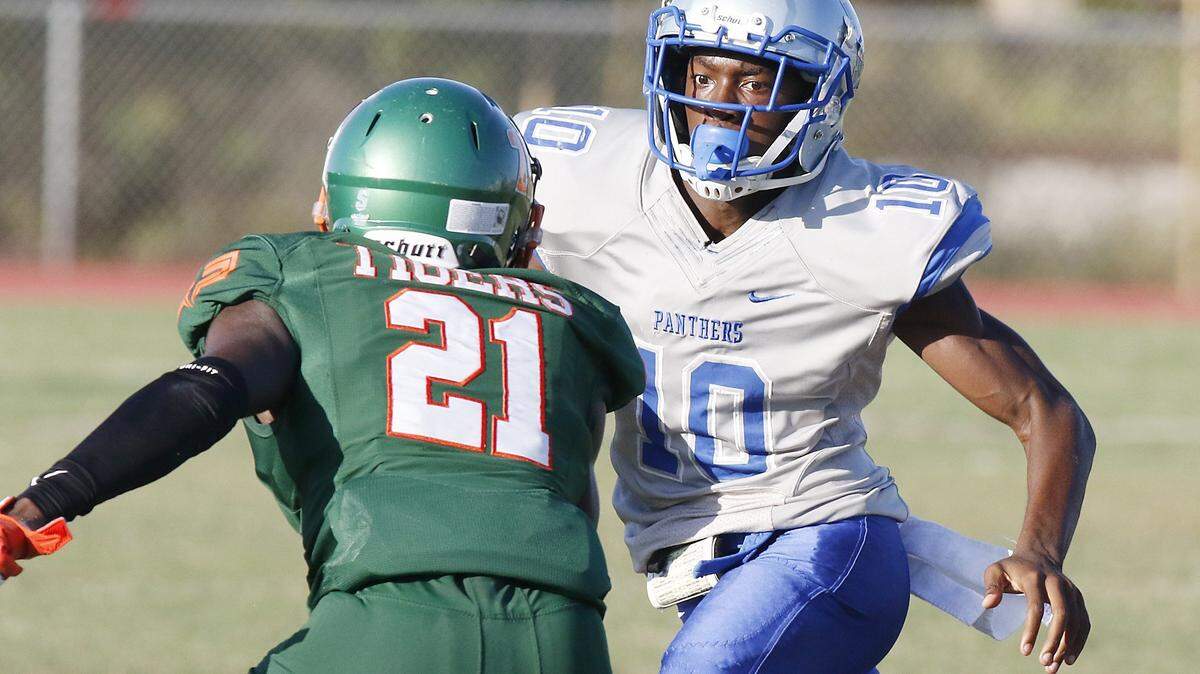 Dillard Panthers’ quarterback Zamir Jones (10) tries to escape with the ball during the football game against Blanche Ely Tigers on Saturday, Nov. 2, 2019 at Blanche Ely HS in Pompano Beach