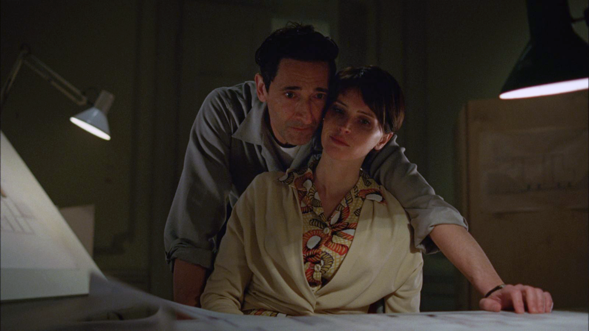 “The Brutalist” narrates 30 years in the life of László Tóth (Adrien Brody), a Hungarian-born Jewish architect and Holocaust survivor. Shown here with Felicity Jones.