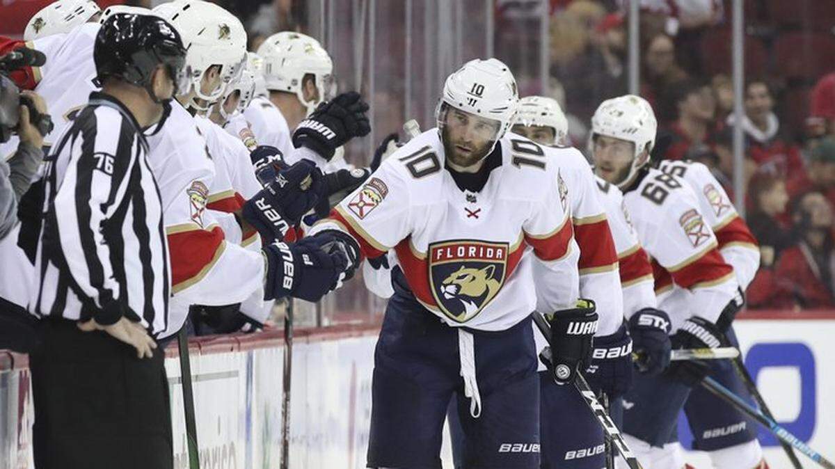 Florida Panthers right wing Brett Connolly (10) celebrates with teammates after scoring a second goal in the second period of an NHL hockey game against the New Jersey Devils, Monday, Oct. 14, 2019, in Newark, N.J.