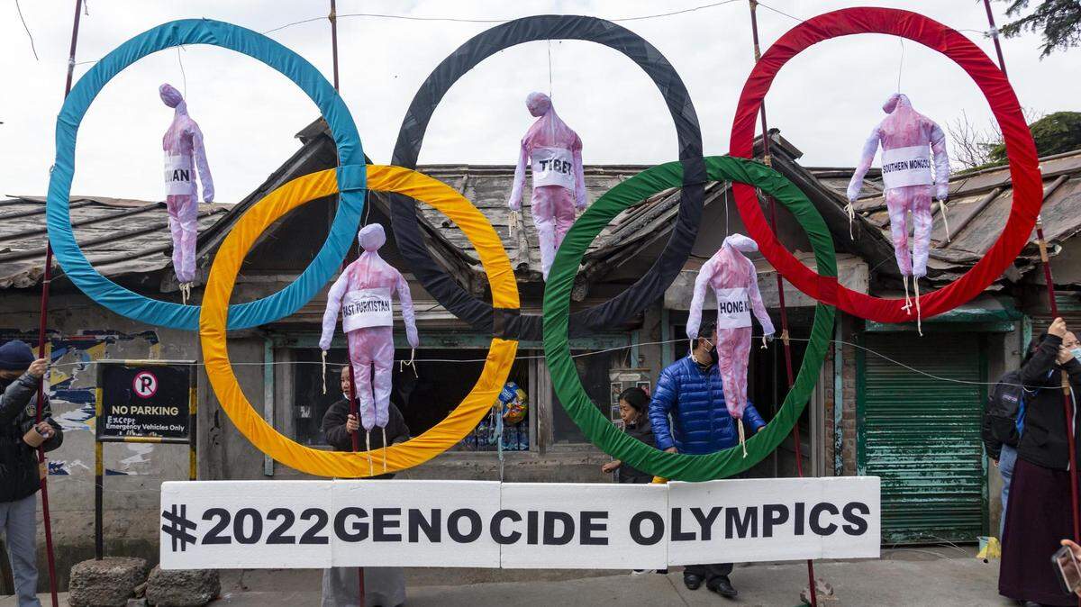 In February 2021, Tibetan exiles in Dharmsala, India, use the Olympic rings as a prop to protest against the holding of 2022 Winter Olympics in Beijing.