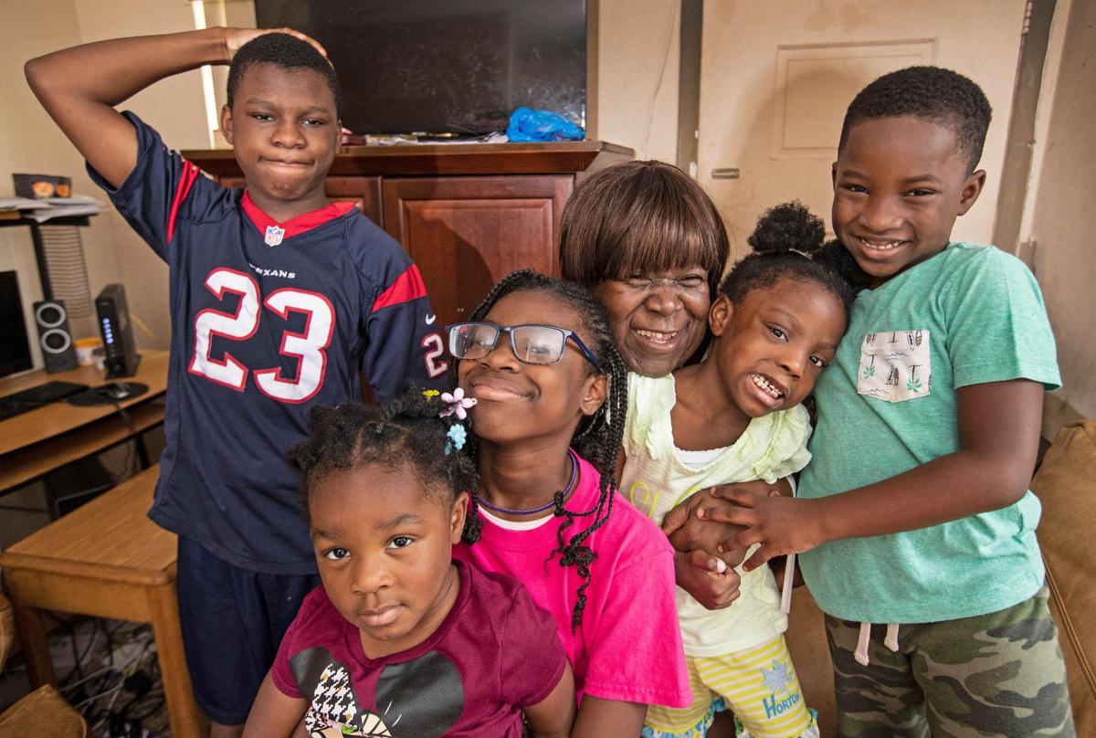 Joan Pratt, 62, gathers her grandchildren, Isiah, 13, Oliviea, 10, holding Abigail, 3, Terylin, 5, and Loyal, 6, left to right, at their Liberty City home.