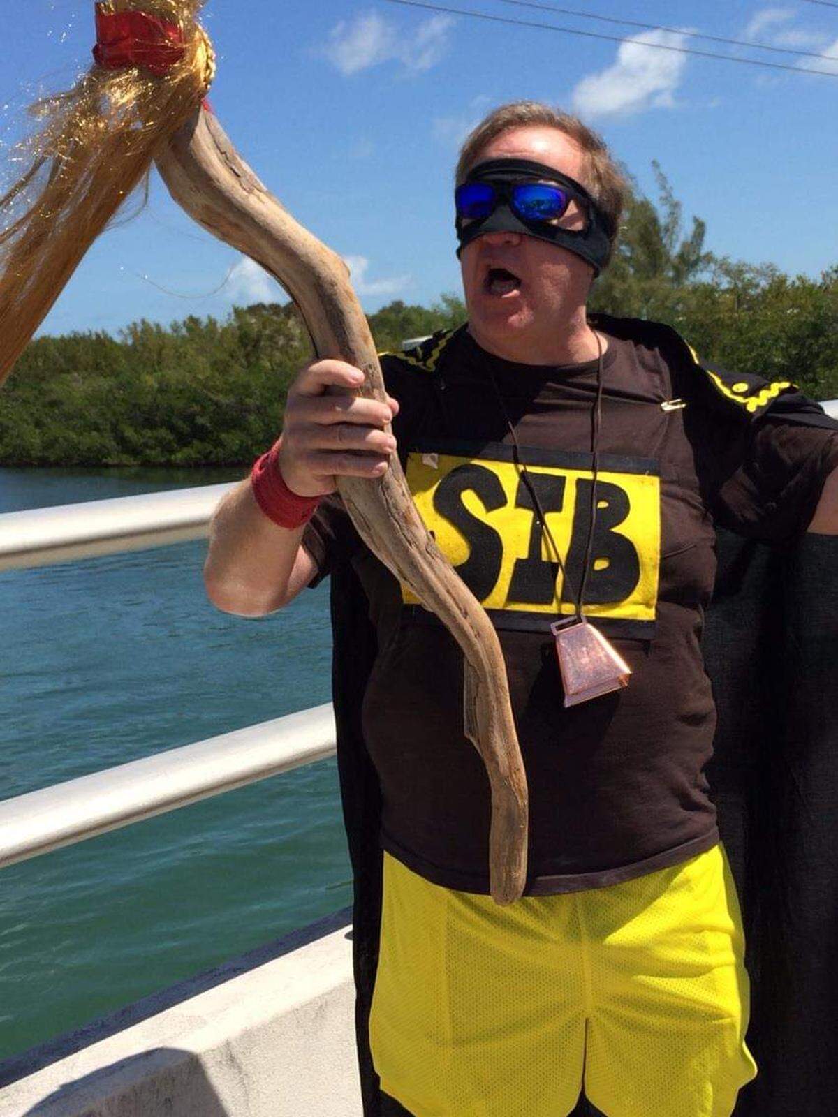 Tom Robinson, aka “Stock Island Boy,” carries a “torch” at a charity race in Key West in 2014.