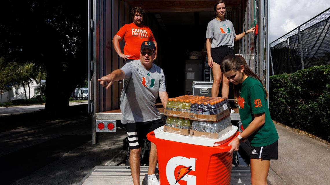 Bryan “Goose” Gossett, left, the equipment manager for the University of Miami, helps the equipment team load the truck for the Pop Tarts Bowl on Thursday, Dec. 19, 2024, outside of the Hecht Athletic Center in Coral Gables, Fla.