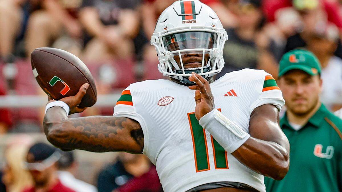Miami Hurricanes quarterback Jacurri Brown (11) throws a pass during warmups before the game against the Florida State Seminoles at Doak Campbell Stadium in Tallahassee on Saturday, November 11, 2023.