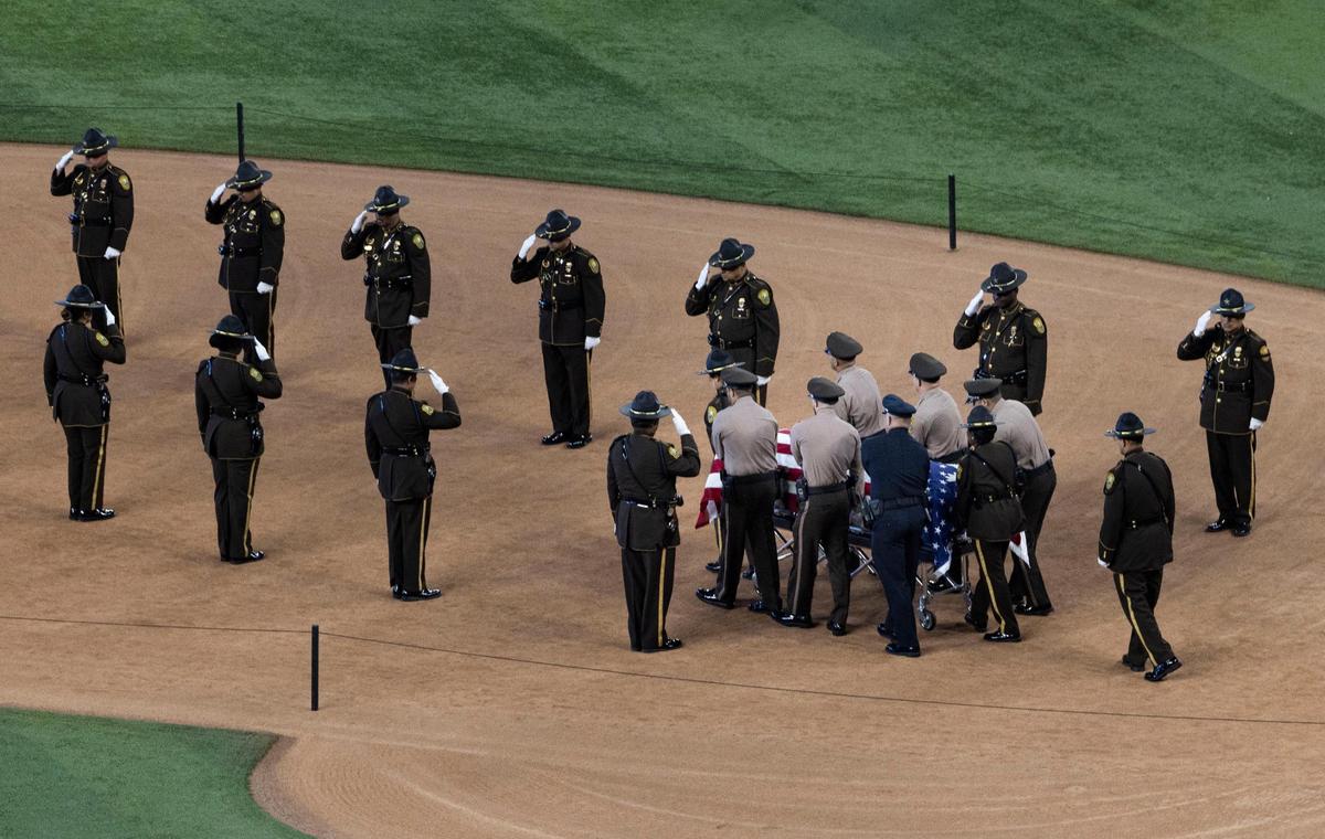 The casket of Officer Cesar “Echy” Echaverry of the the Miami-Dade Police Department is carried in during his Rendering of Honors on Wednesday, Aug. 24, 2022, at loanDepot park in Miami.