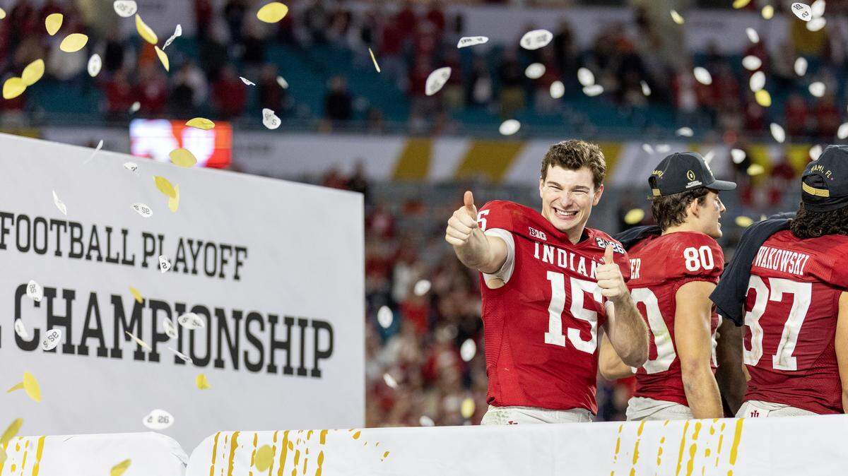Indiana quarterback Fernando Mendoza (15) greets fans as he celebrates with Hoosiers wide receiver Charlie Becker (80) and tight end Riley Nowakowski (37) after a 27-21 victory over the Miami Hurricanes in the College Football Playoff national championship game at Hard Rock Stadium on Monday, Jan. 19, 2026, in Miami Gardens, Fla.
