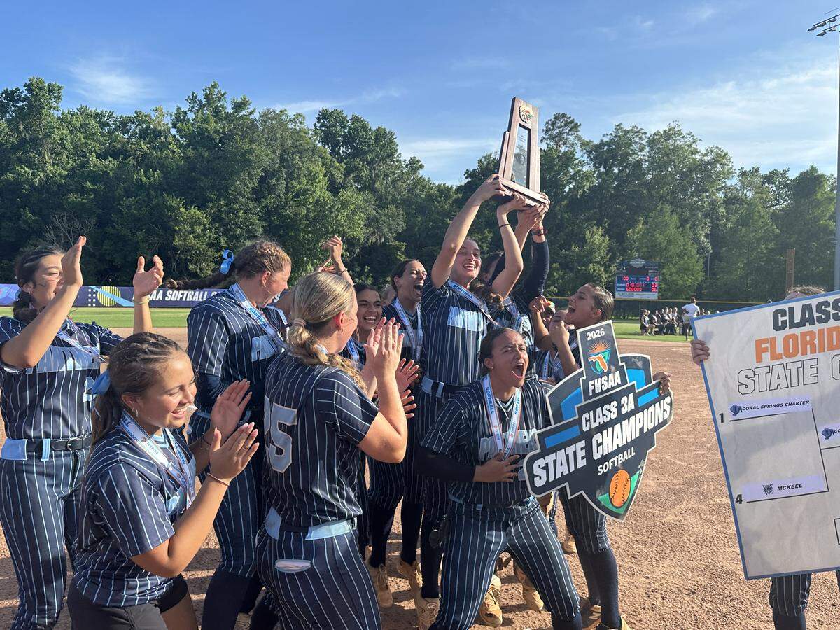 Coral Springs Charter softball players raise the state championship trophy after beating Eustis to win the Class 3A state championship on Friday at Boombah-Soldiers Creek Park in Longwood, Fla.