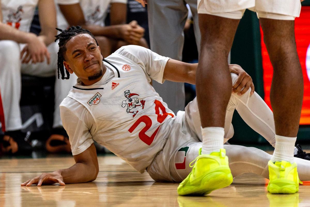 Hurricanes guard Nijel Pack (24) reacts to hurting his knee during the first half of an NCAA basketball game against Boston College at Watsco Center in Coral Gables, Florida on Wednesday, March 6, 2024.