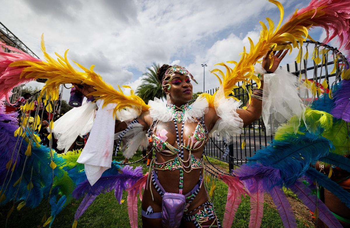Dominique Berridge poses in her costume before lining up with the band “K-paya” for the Parade of Bands at Miami Carnival on Sunday, Oct. 13, 2024, at Miami-Dade County Fair Expo.