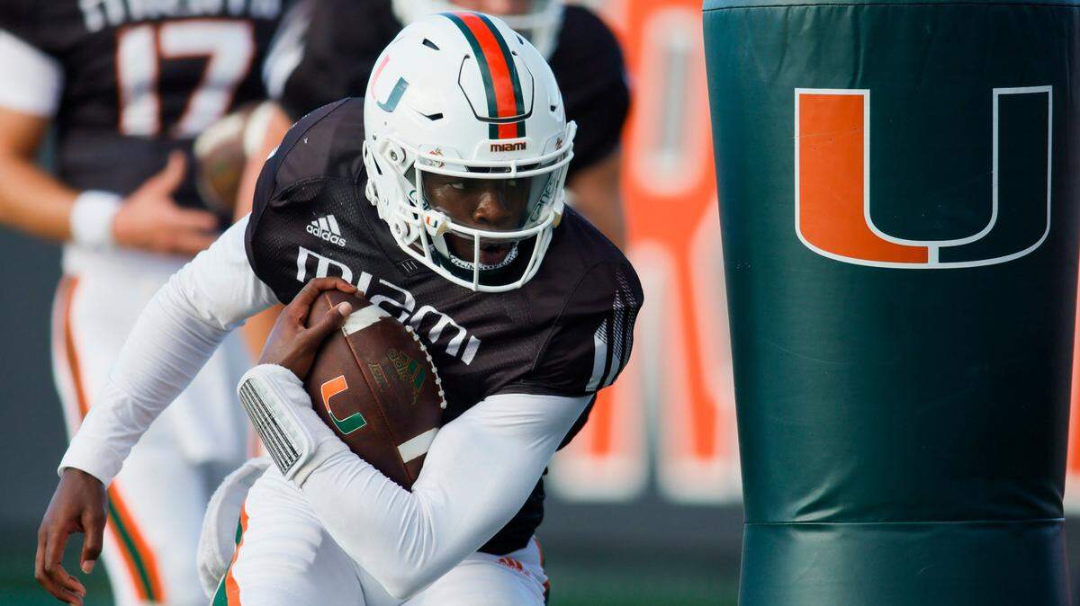 Miami Hurricanes quarterback Jacurri Brown (11) works out during football practice at the University of Miami campus in Coral Gables, Florida, Thursday, March 23, 2023.