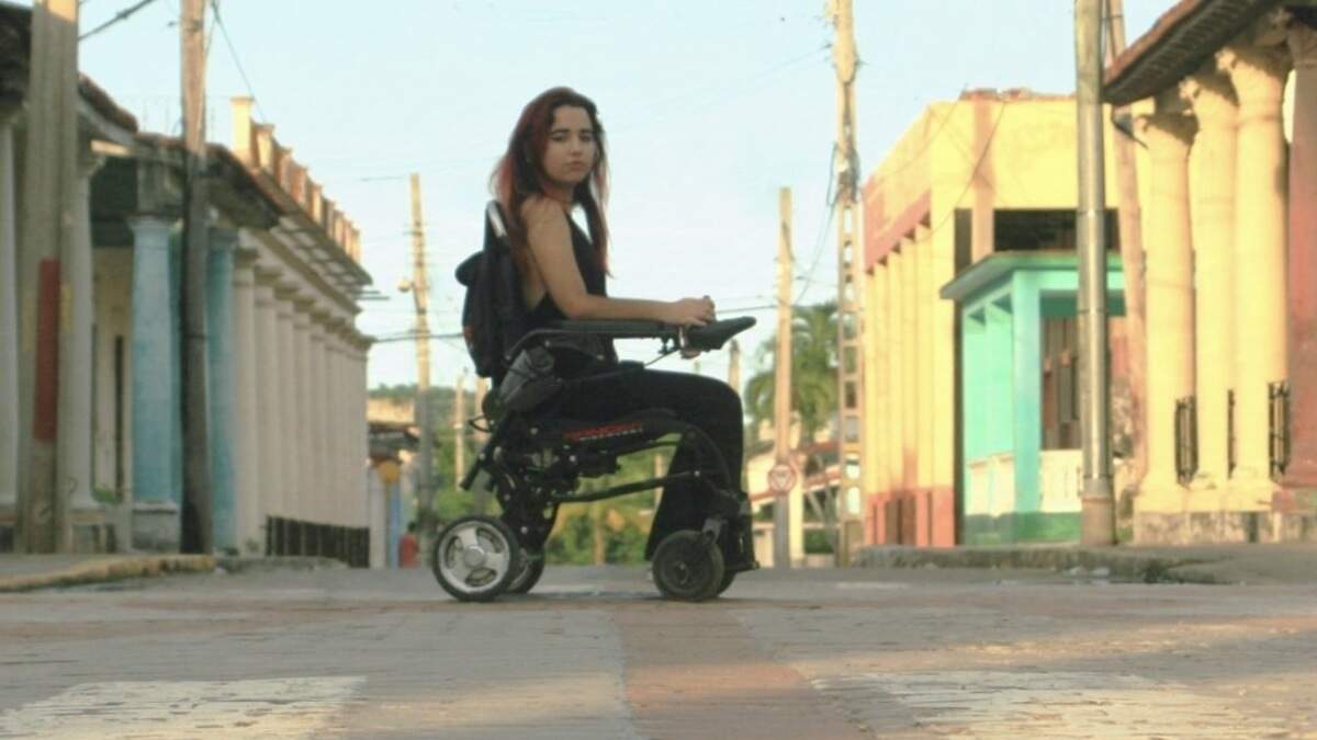 Marlys Ruiz, a Cuban content creator who focuses on accessibility and inclusion, sits in her wheelchair on a street in Isla de la Juventud, the island just south of the Cuban mainland. Ruiz says creating content from Cuba means working around blackouts, poor internet connection and public spaces that are often difficult for people with disabilities to navigate.