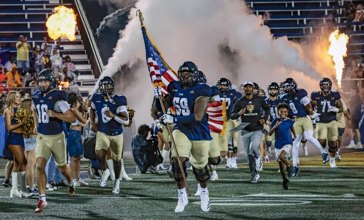 The Florida International University Panthers rush the field along with Florida International University Panthers head coach Willie Simmons for their football game against the Bethune Cookman Wildcats at FIU's Pitbull Stadium in Miami, Florida, on Friday, August 29, 2025.
