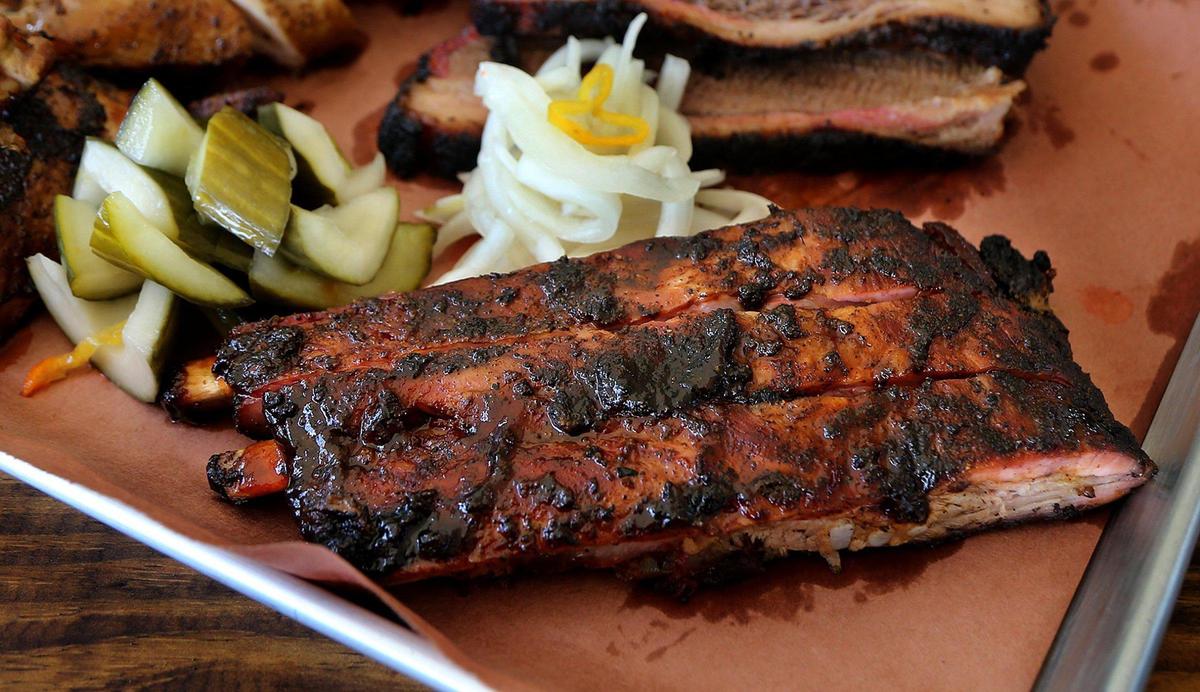 Spare ribs at The Drinking Pig have a jerk rub and are served with pickled onions and cucumbers.
