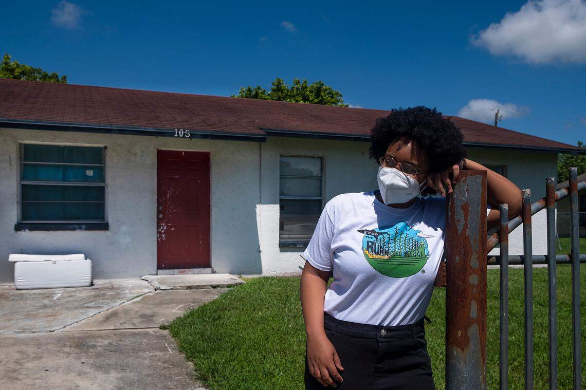 Kil’mari Phillips stands outside her home in South Bay, Florida — a few hundred feet away from Rosenwald Elementary School and the acres of sugarcane adjacent to it in Palm Beach County.