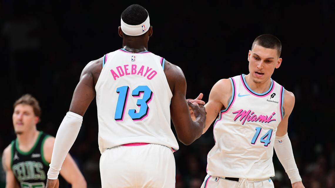 Miami Heat center Bam Adebayo (13) is congratulated by guard Tyler Herro (14) after making a basket during the second half against the Boston Celtics at TD Garden.