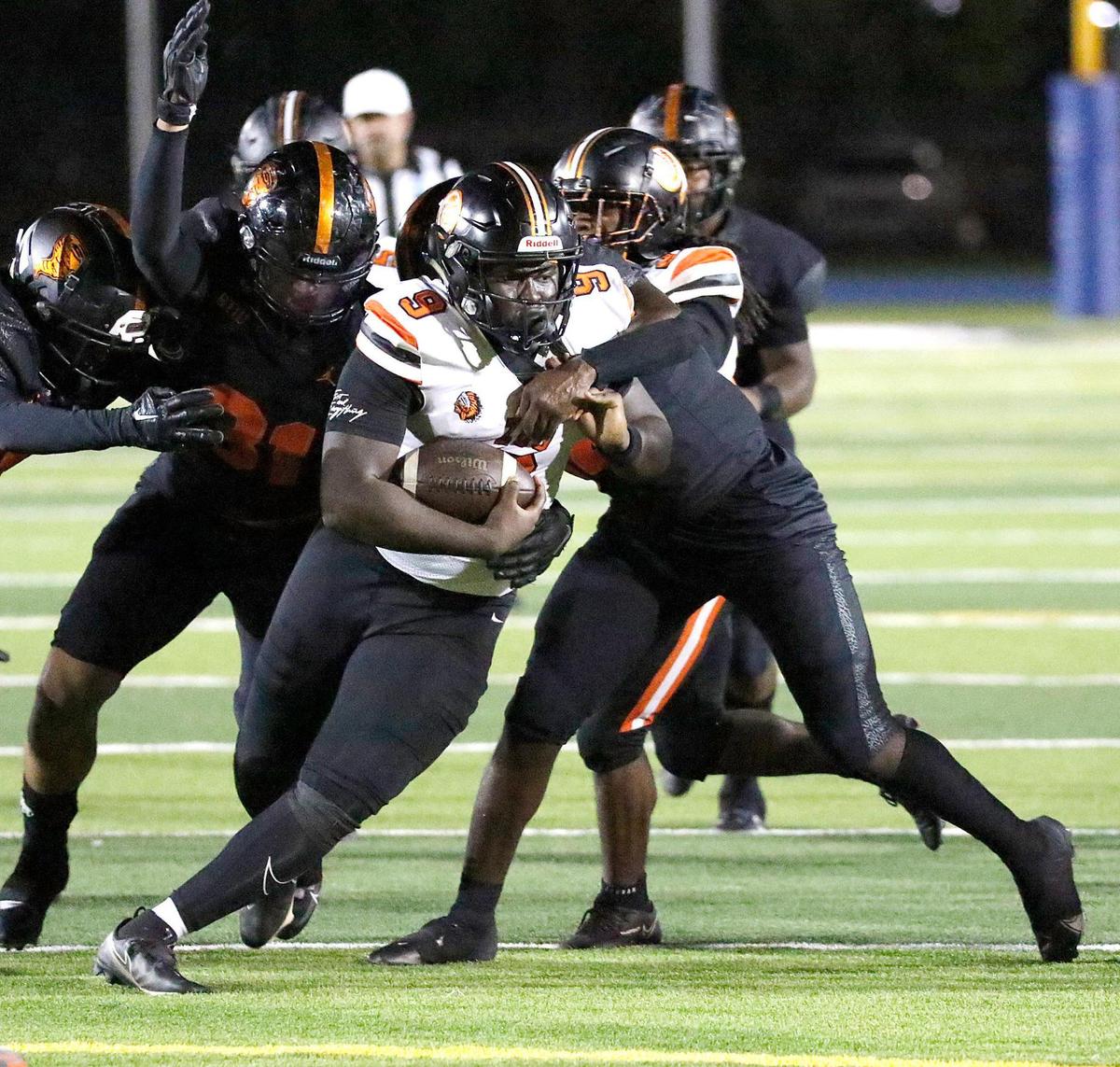 Booker T. Washington Tornadoes tackle Carol City Chiefs quarterback Max Civil (9) during football game on Thursday, November 10, 2022 at Traz Powell Stadium in Miami. Andrew Uloza / for Miami Herald