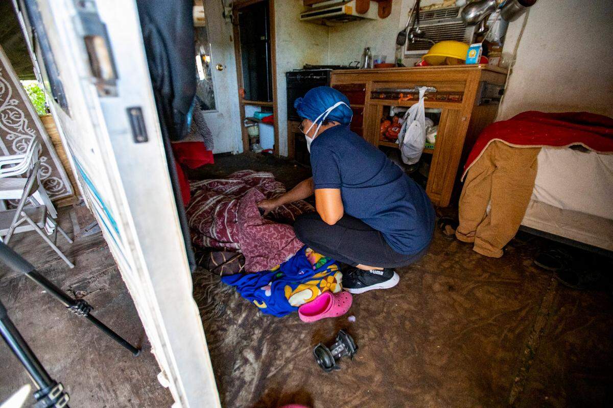 A Miami-Dade County Public School’s employee who had taken a lead role on assisting the kids with virtual learning attempts to wake up a migrant child who tried to sleep through ‘class’ during the coronavirus pandemic in South Florida on Thursday, May 21, 2020.