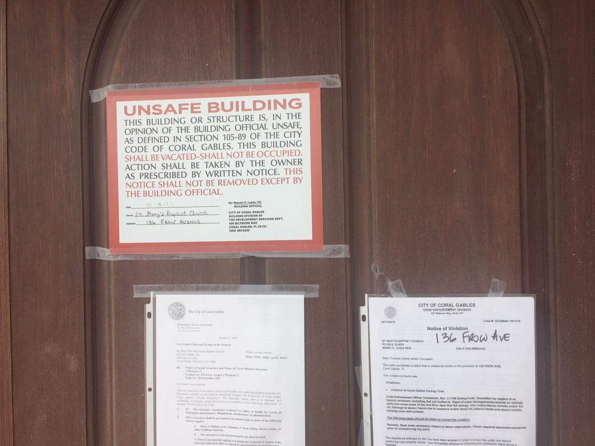Notices of building violations posted by the city of Coral Gables on the door of St. Mary’s FIrst Missionary Baptist Church in historically black west Coconut Grove.