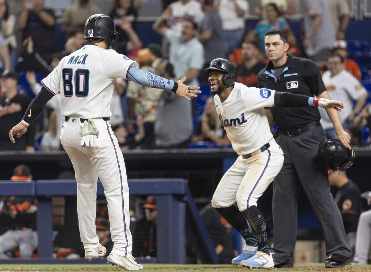 Miami Marlins catcher Joe Mack (80) celebrates with shortstop Otto Lopez (6) after scoring a walk-off run against the Baltimore Orioles in the ninth inning of their MLB game at loanDepot park on Thursday, May 7, 2026, in Miami, Fla.