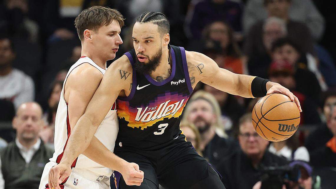 Dillon Brooks #3 of the Phoenix Suns handles the ball against Pelle Larsson #9 of the Miami Heat during the first half of the NBA game at Mortgage Matchup Center on January 25, 2026 in Phoenix.