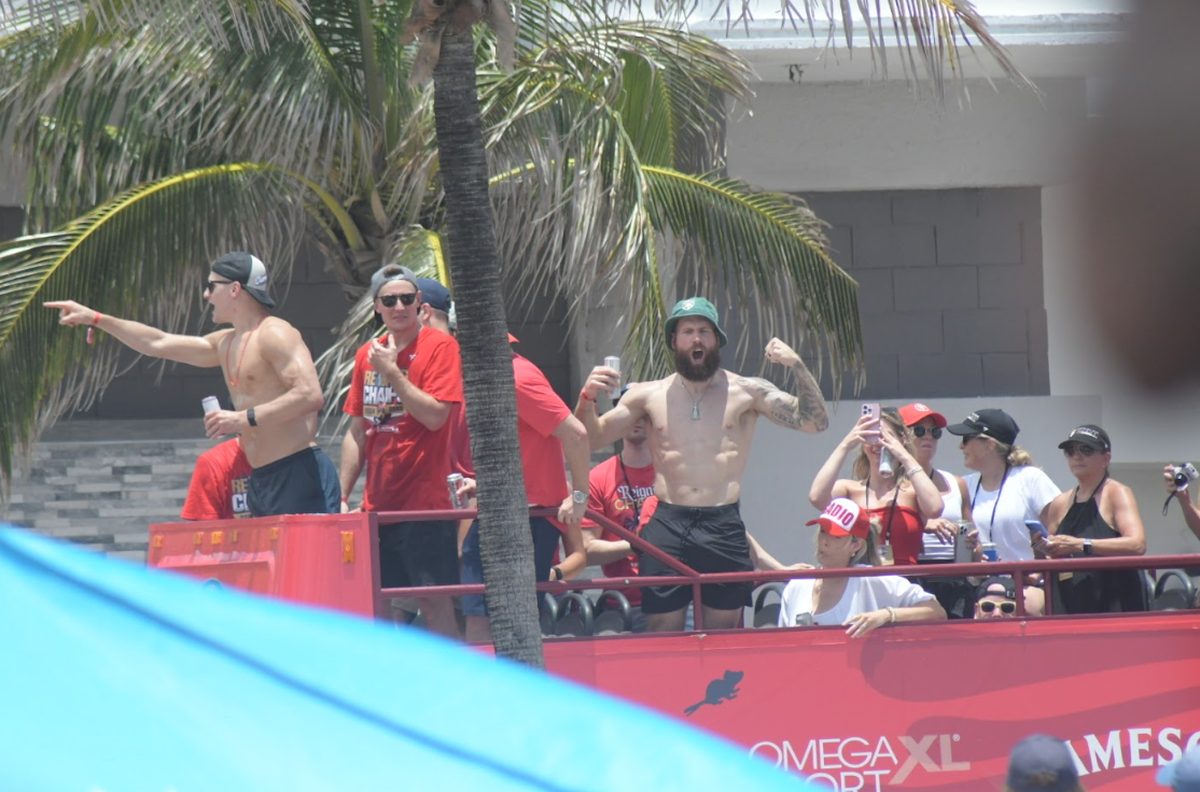 Panthers center Nico Sturm (no shirt), backup goalie Vitek Vanecek (shirt) and right wing Jonah Gadjovich (no shirt) on a bus with their families.