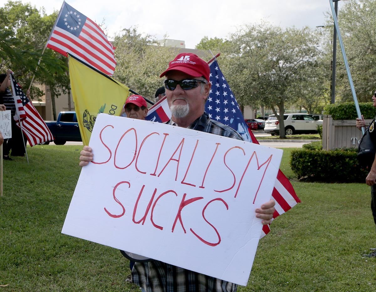 A group of people protested outside of the Bonaventure Town Center Club in Weston as House Speaker Nancy Pelosi met with Ambassador Carlos Vecchio and local Venezuelan community leaders on Thursday, October 3, 2019.