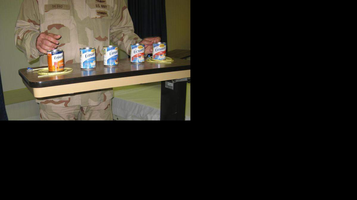 A Navy doctor at Guantanamo who refused to have his face photographed and called himself "'Cmdr. SMO," short for Senior Medical Officer, told visiting reporters in September  2010 that one captive hadn't consumed solid food for four years at that point. He was showing reporters the size of the feeding tube and flavors used in the Guantanamo hunger striker renourishment program in this image that was approved for release by a sailor at the US Navy base at Guantanamo Bay, Cuba.