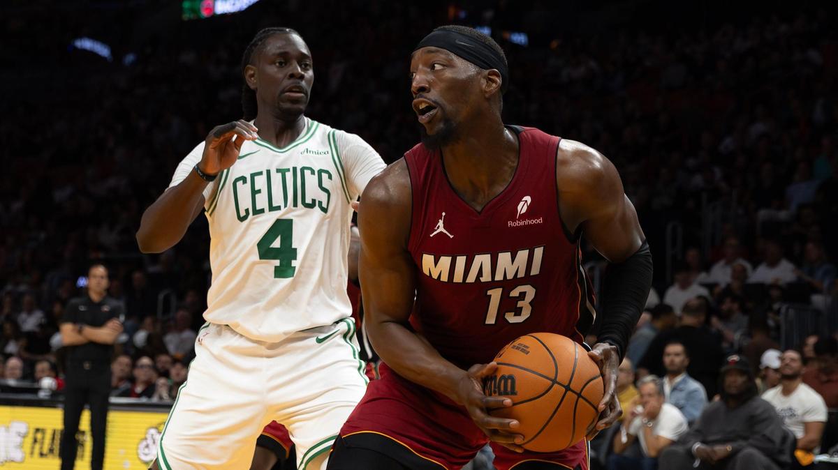 Miami Heat center Bam Adebayo (13) looks to pass against Boston Celtics guard Jrue Holiday (4) during the first half of their NBA game at Kaseya Center on March 14, 2025, in Miami.