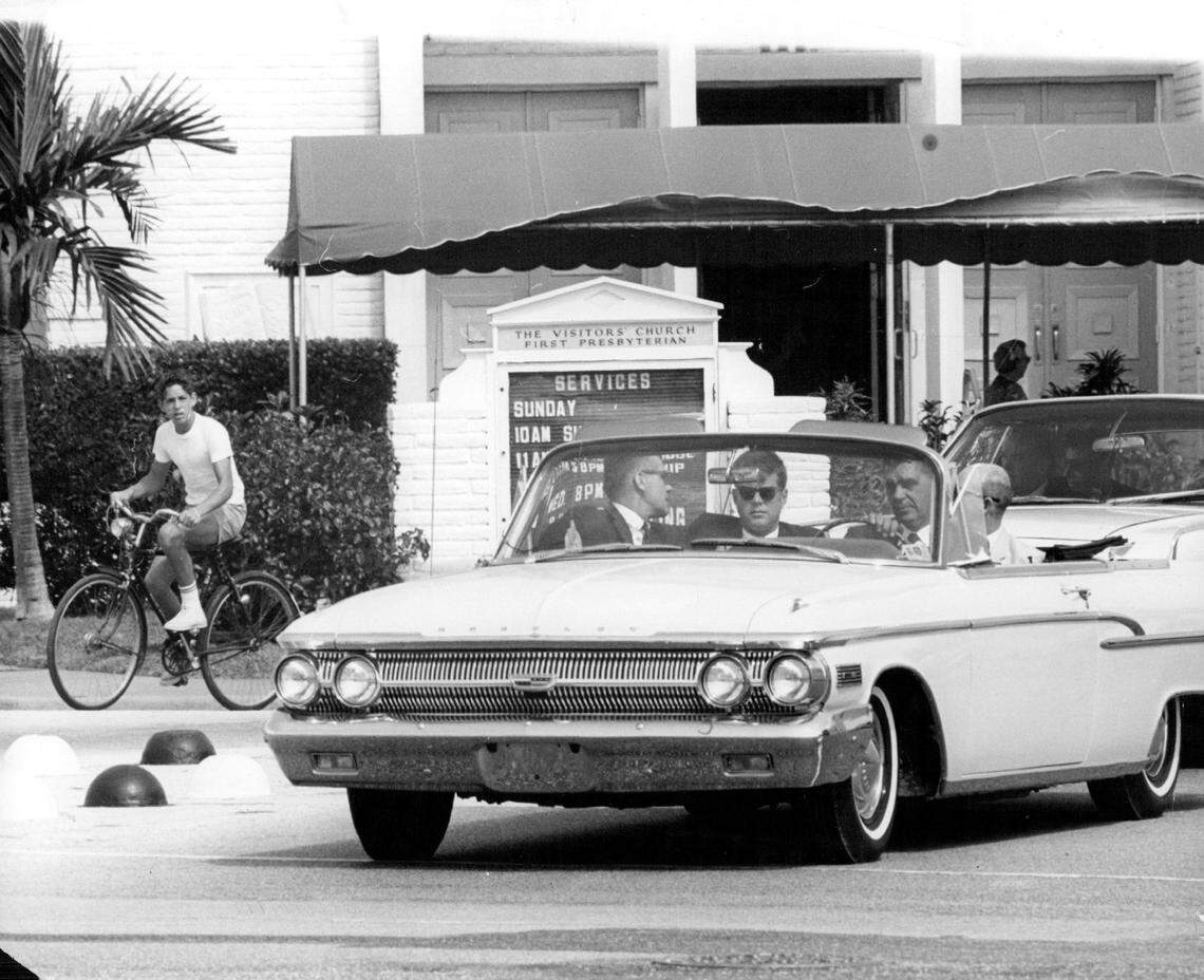 In 1962, President John F. Kennedy stops for a red light in Miami Beach at 71st Street and Indian Creek Drive in an open car after leaving St. Joseph’s Catholic Church.