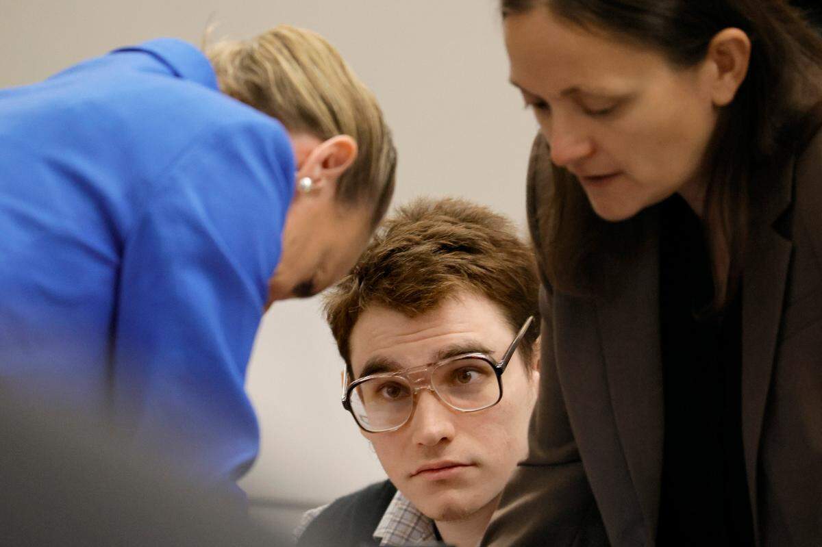 Marjory Stoneman Douglas High School shooter Nikolas Cruz is shown at the defense table as Assistant Public Defender Melisa McNeill, left, and sentence mitigation specialist Kate O’Shea, a member of the defense team, speak during the penalty phase of the trial of Marjory Stoneman Douglas High School shooter Nikolas Cruz at the Broward County Courthouse in Fort Lauderdale on Monday, August 22, 2022. Cruz previously plead guilty to all 17 counts of premeditated murder and 17 counts of attempted murder in the 2018 shootings.