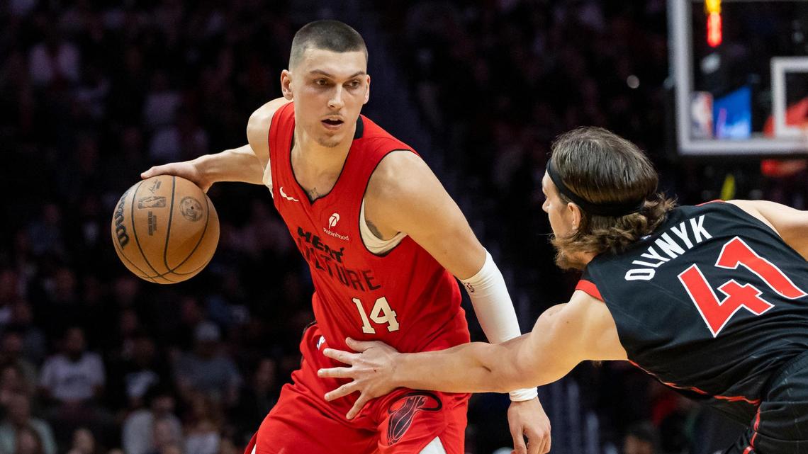 Miami Heat guard Tyler Herro (14) dribbles the ball as Toronto Raptors forward Kelly Olynyk (41) defends in the second half of their NBA game at Kaseya Center on Dec. 12, 2024, in downtown Miami.
