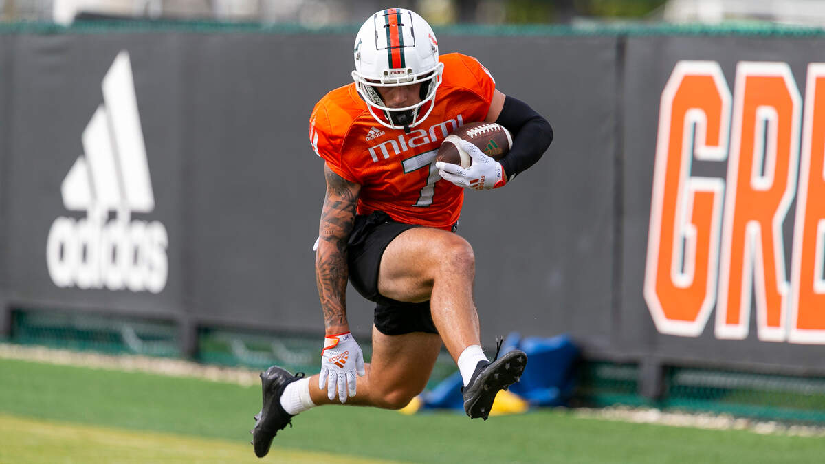 Miami Hurricanes wide receiver Xavier Restrepo (7) jumps after catching the ball during a practice drill at the University of Miami’s Greentree Practice Fields on Monday, Aug. 8, 2022, in Coral Gables, Fla.