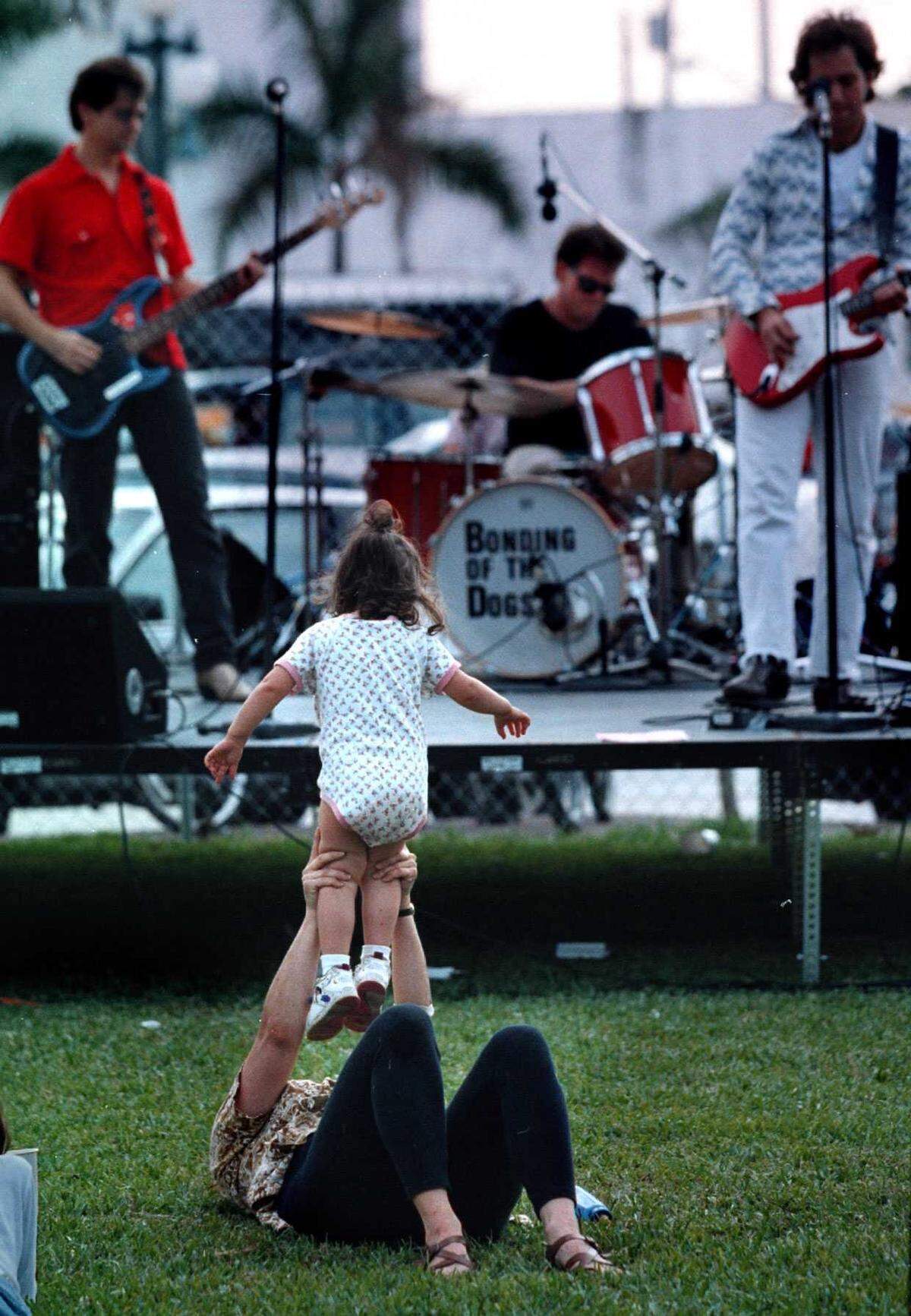 This was the 10th annual Footy's Y-100 Wing Ding in 1996 at Young Circle in Hollywood. The benefit event featured wings from South Florida restaurants and nationally known musical acts. Here, Angelena Kauffman, 2, from Davie, gets lifted by mom, Rachel, while listening to rock band Bonding of the Dogs.