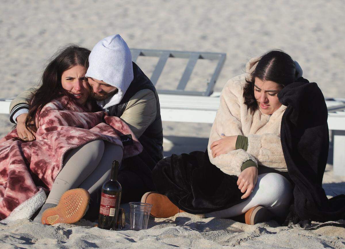 If you hit the beach, you may need to dress like this for the wind chill. Beachgoers Jennifer Quintana, 23, and boyfriend Cesar Reyes, 22, center, and Gabriela Alcantara, 20, left, kept warm in January during a similar cold snap.