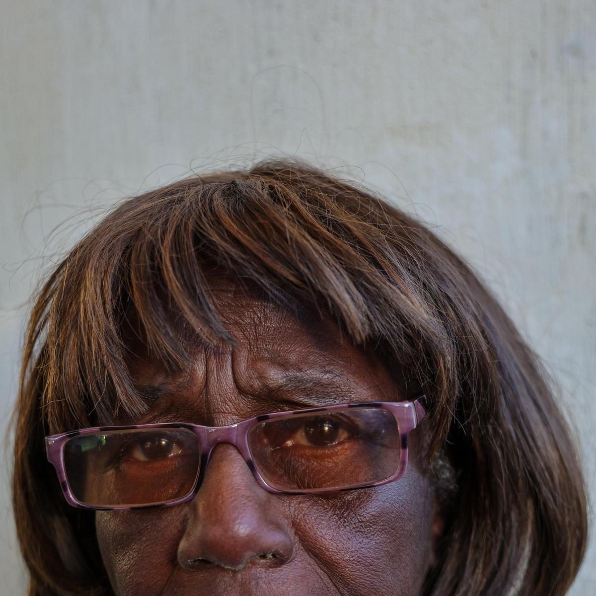 Ethline Southerland, 75, leans against an overpass pillar as she and others wait for a free, warm meal and clothing donations on Thursday, Jan. 9, 2025, in Miami.