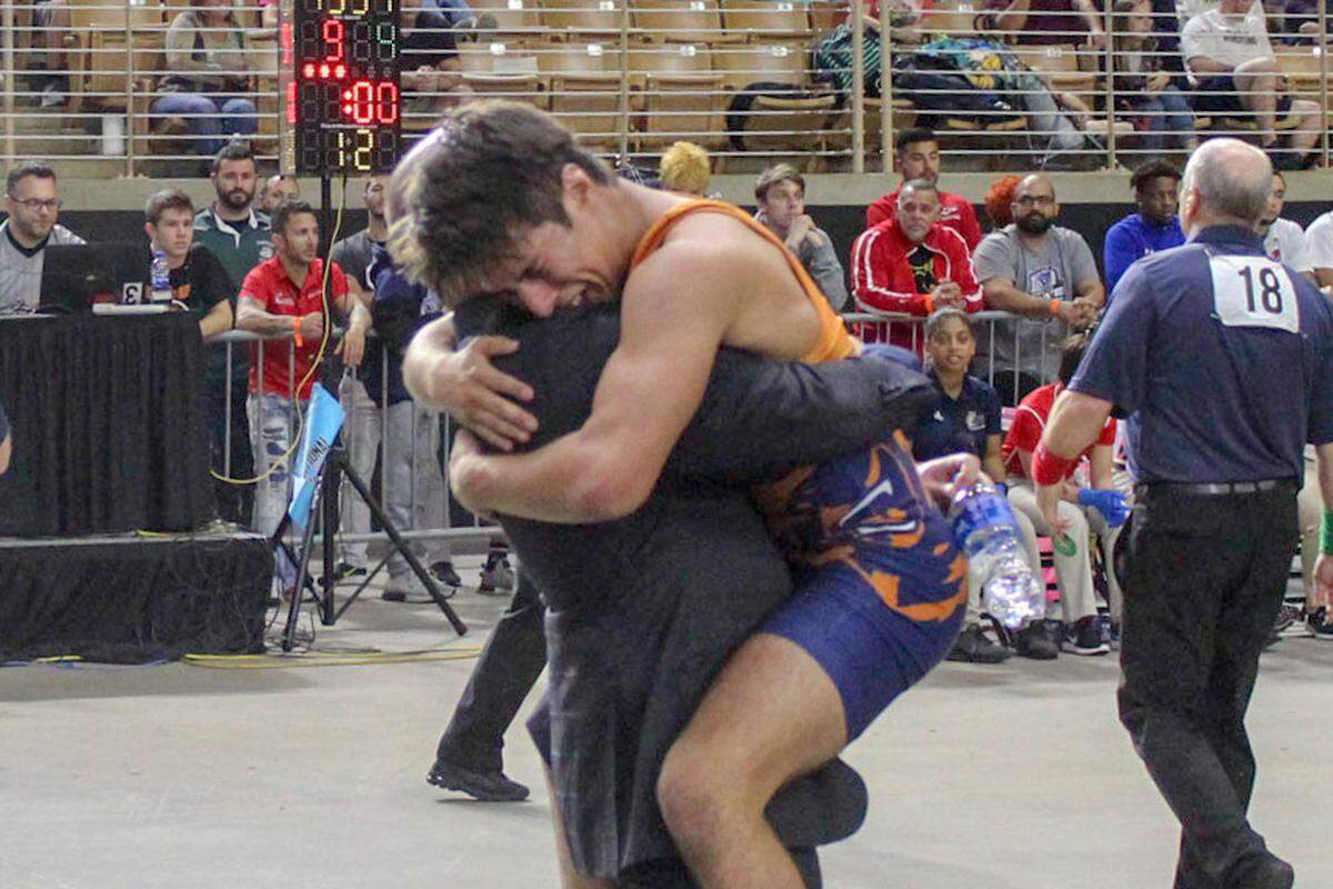 Mater Lakes’ Nicholas Luna celebrates with coach Brandon Neifeld after winning the Class 1A 120 lbs state title on Saturday, March 9, 2019, at Silver Spurs Arena in Kissimmee, Florida.
