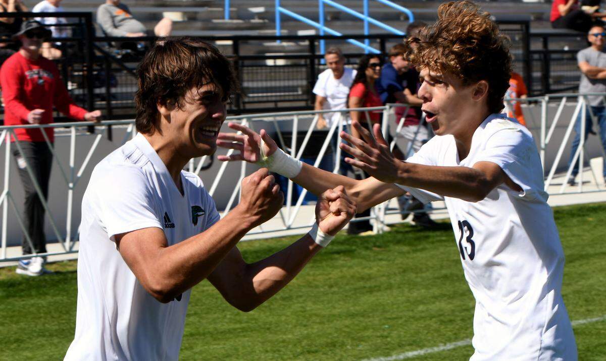 Downtown Doral junior Jose Uzcategul (10) celebrates his goal with freshman teammate Luca Cianci (13) in the first half of the FHSAA Class 3A state championship game against Tampa Prep on Saturday at Lake Myrtle Park in Auburndale. The goal tied the game 1-1.