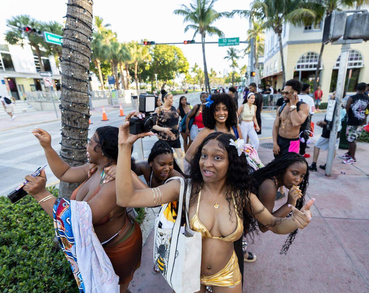 A group of women dance next to The Clevelander.