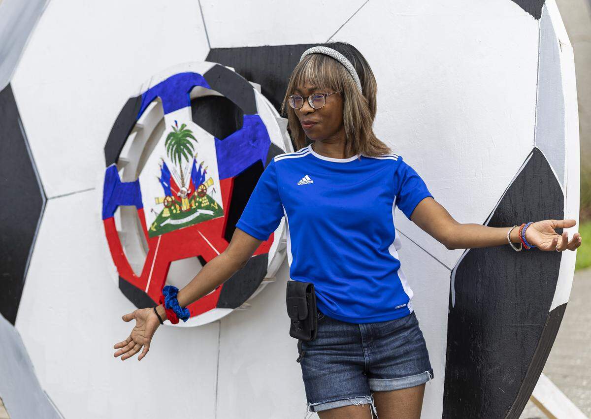 Denise Azemar poses in front of a soccer ball cutout before a meet-and-greet with the Haiti national soccer team at the Museum of Contemporary Art, North Miami on Saturday, May 30, 2026, in North Miami, Fla.
