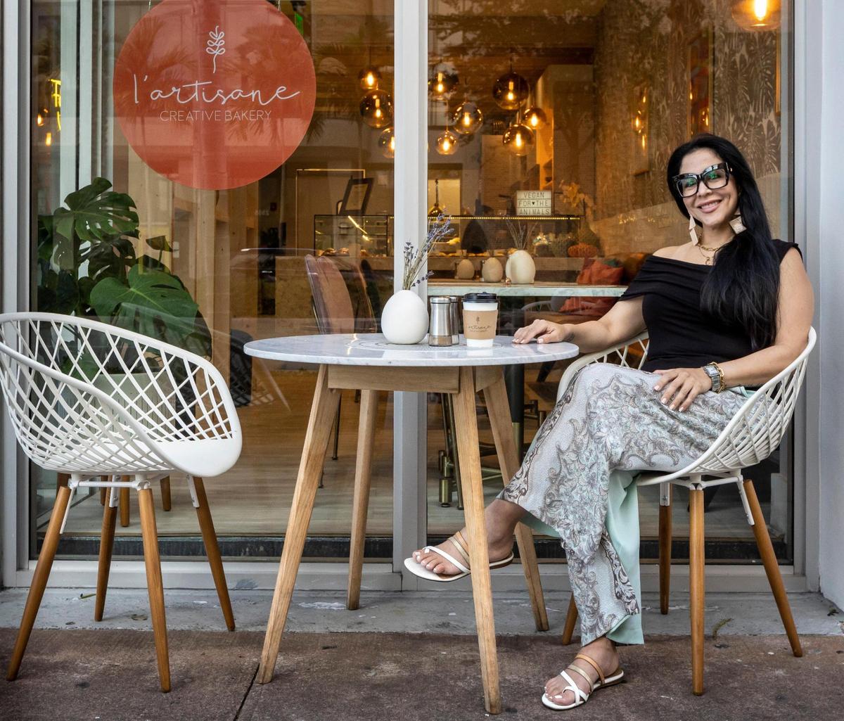 Carolina Molea enjoys the morning fresh air sipping coffee at a small table in front of her bakery, which focuses on vegan pastries.