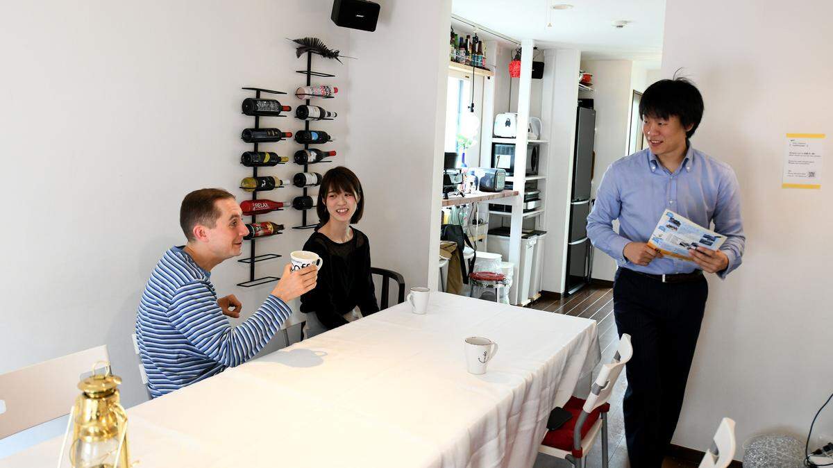 This May 12, 2018 picture shows room rental user Max Ikeda, a Ukrainian-Japanese living in Hiroshima (L), talking with rental house owner Nobuhide Kaneda (R) and his partner Hitomi Watanabe (C) in Tokyo.