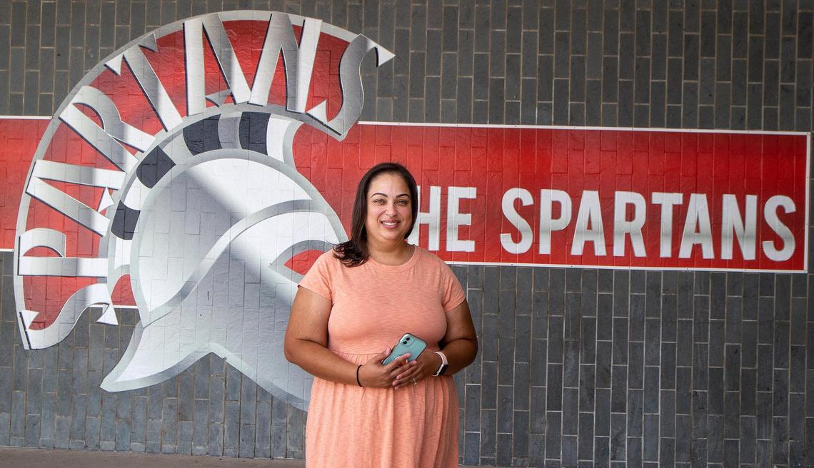 Jennifer Desa, a journalism and social studies teacher at Miami Southridge High, says she’s concerned about how Florida’s new education laws will impact her way of teaching. She posed in front of her school on Friday, Aug. 12, 2022.