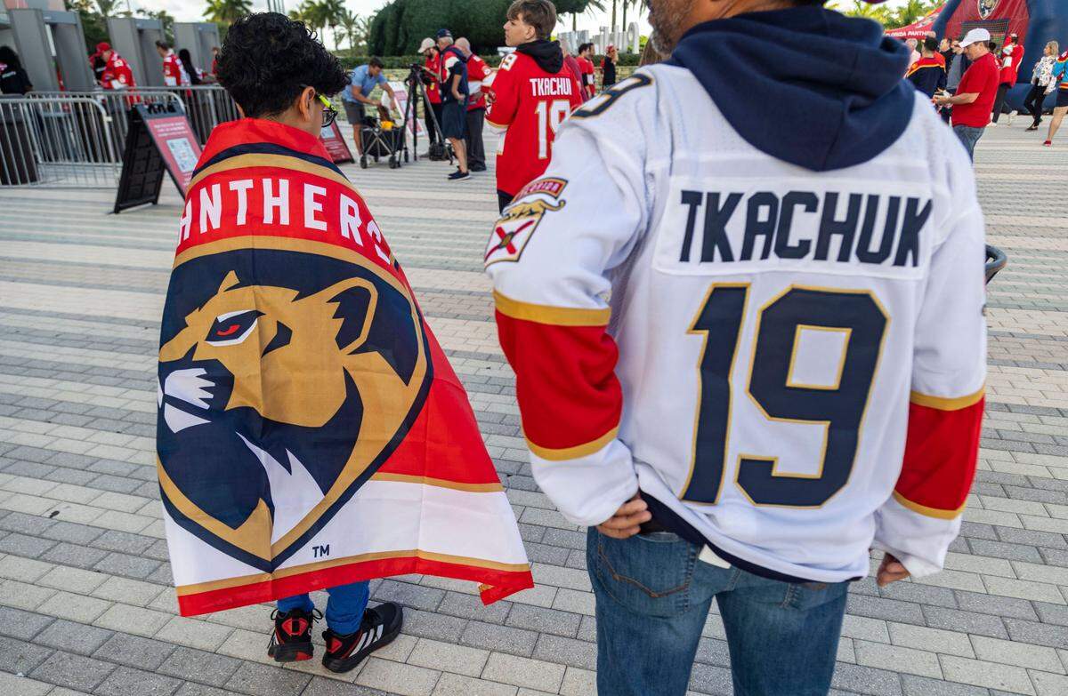 Thirteen year -old Xander Wong, left and his father, Eddie, right arrive at the Arena with plenty of time to spare before the puck drops.