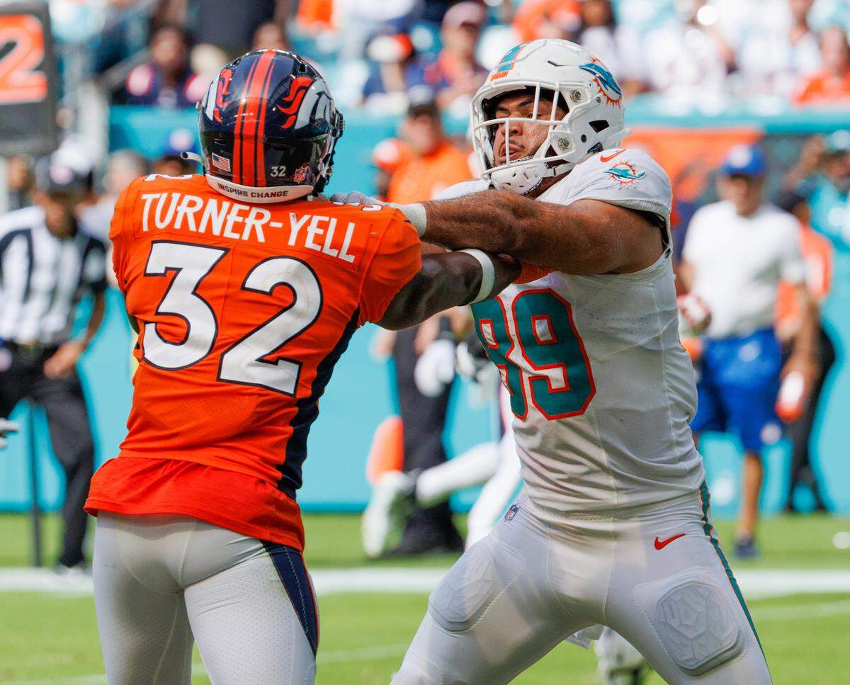 Miami Dolphins tight end Julian Hill (89) blocks Denver Broncos safety Delarrin Turner-Yell (32) during fourth quarter of an NFL football game at Hard Rock Stadium on Sunday, Sept. 24, 2023 in Miami Gardens, Fl.